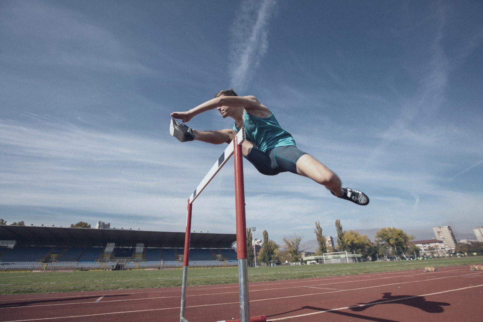Athlete clearing a hurdle