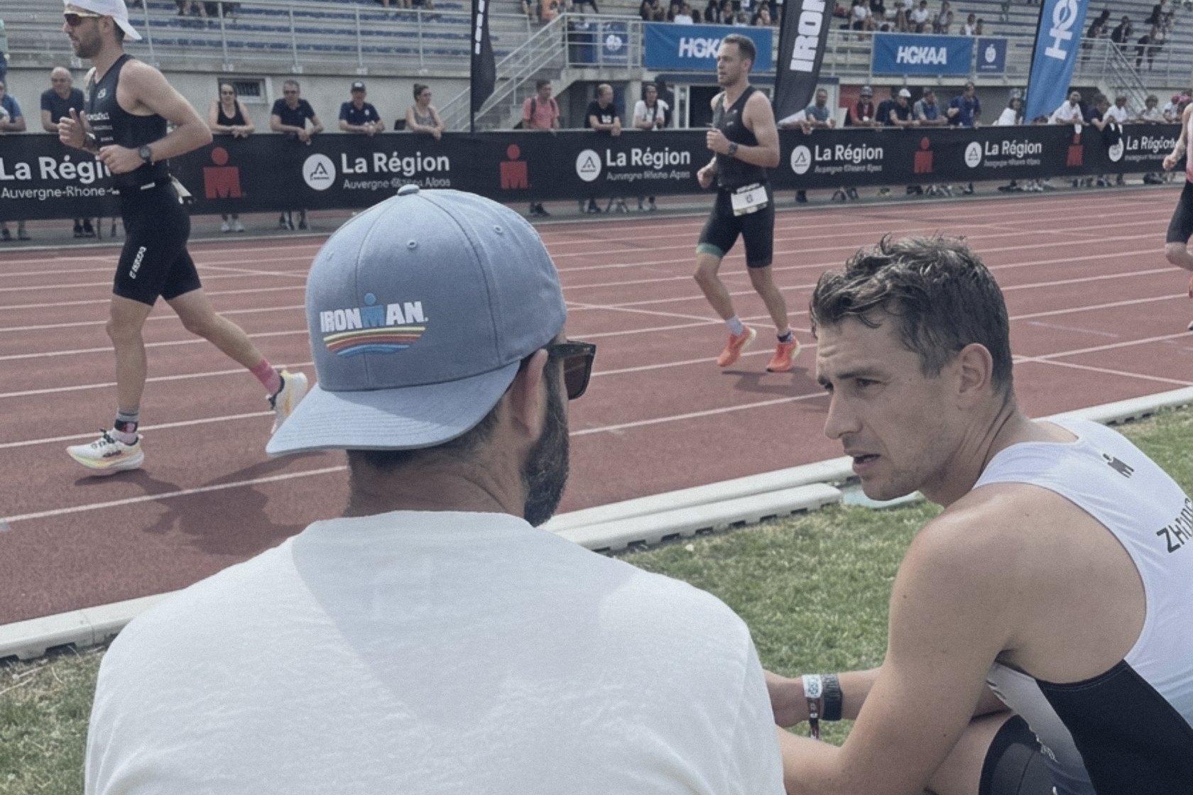 Mike talking with a triathlete trackside at a race